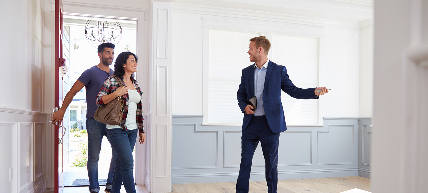 Agent showing a couple a newly built home