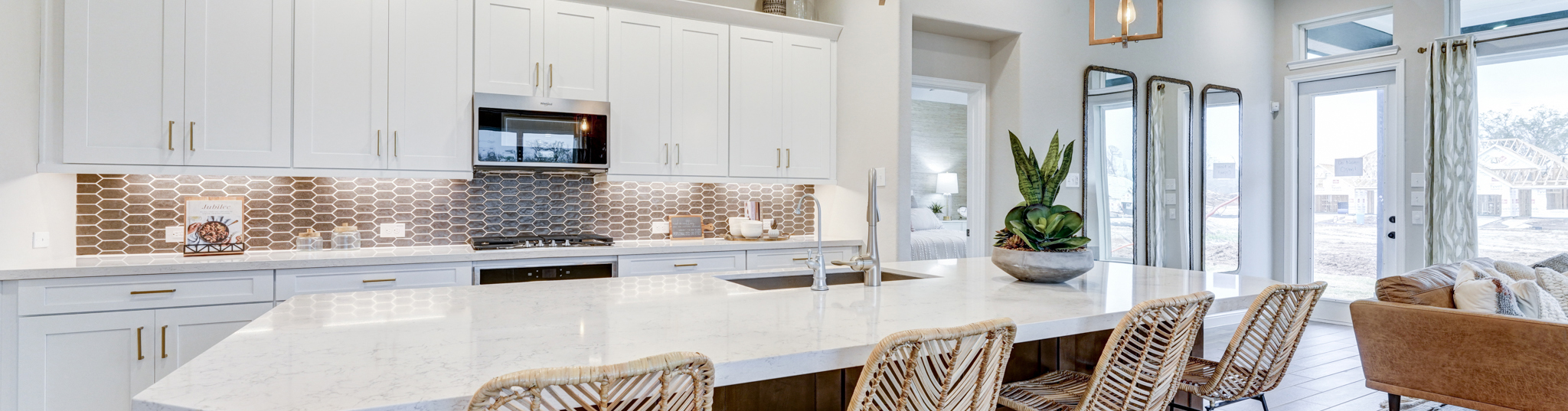 bright open-concept kitchen with marble countertops