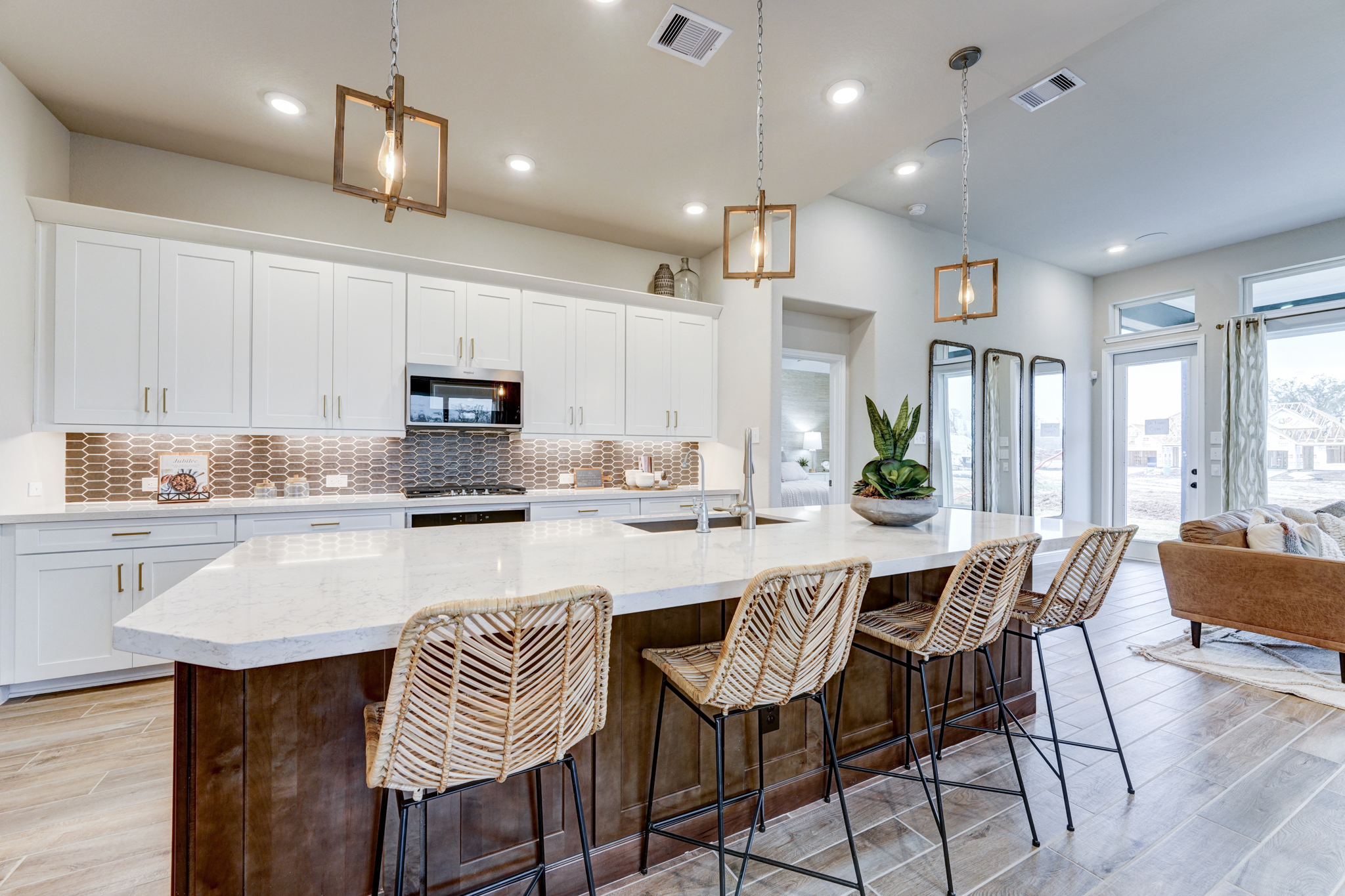 bright open-concept kitchen with marble countertops