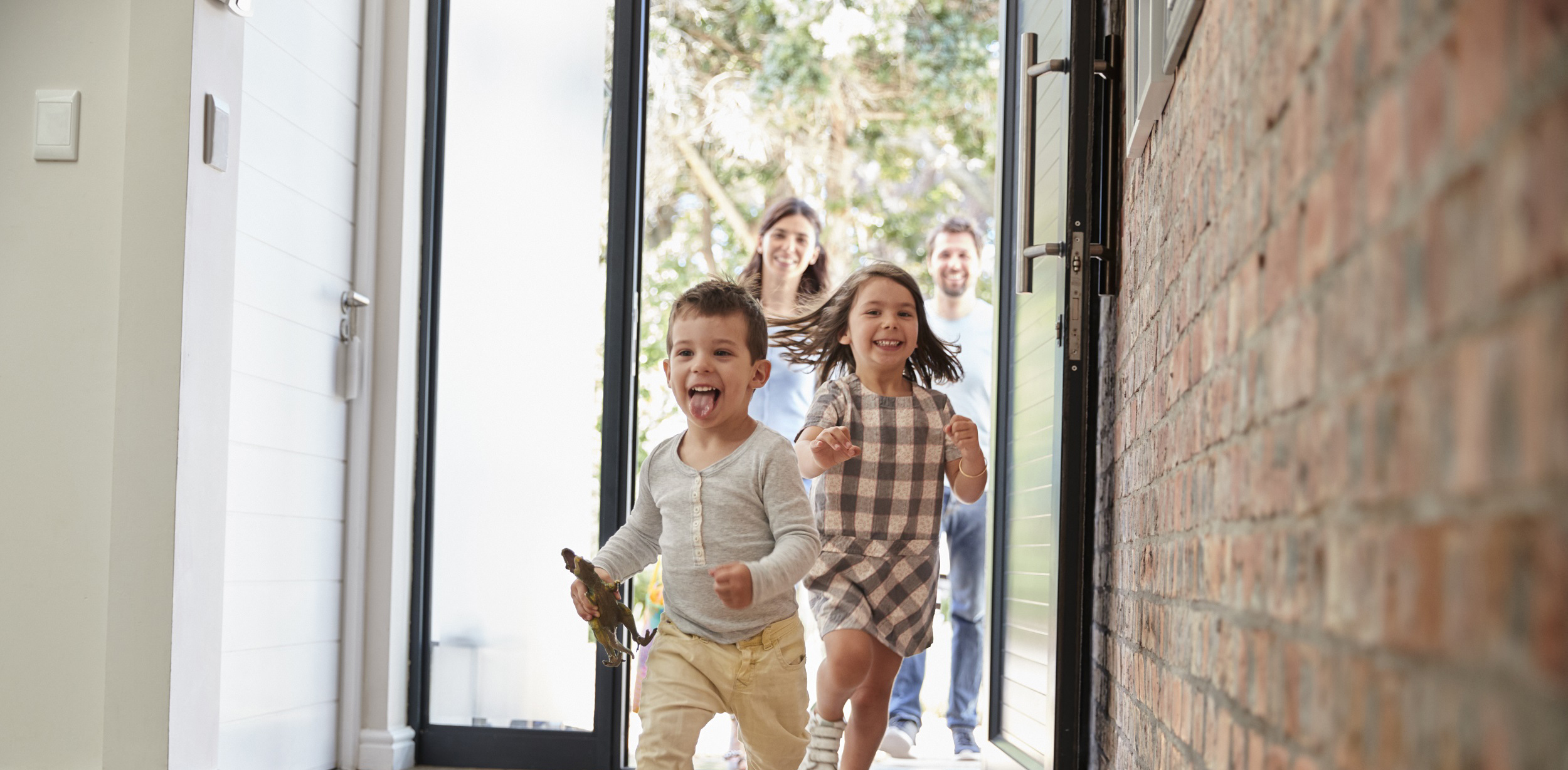 Family entering their newly built home