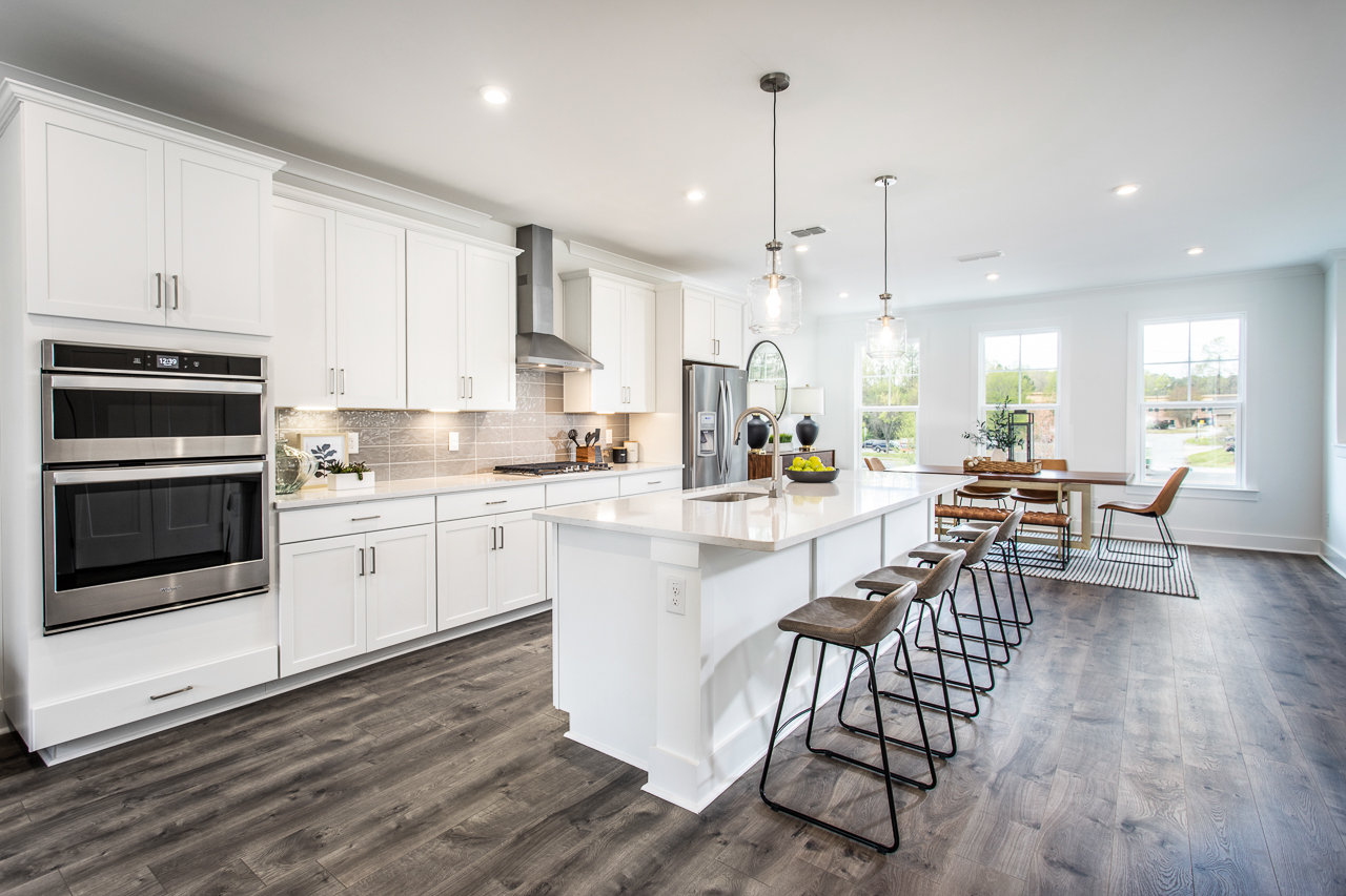 kitchen with white cabinets, large island, and eat-in dining space